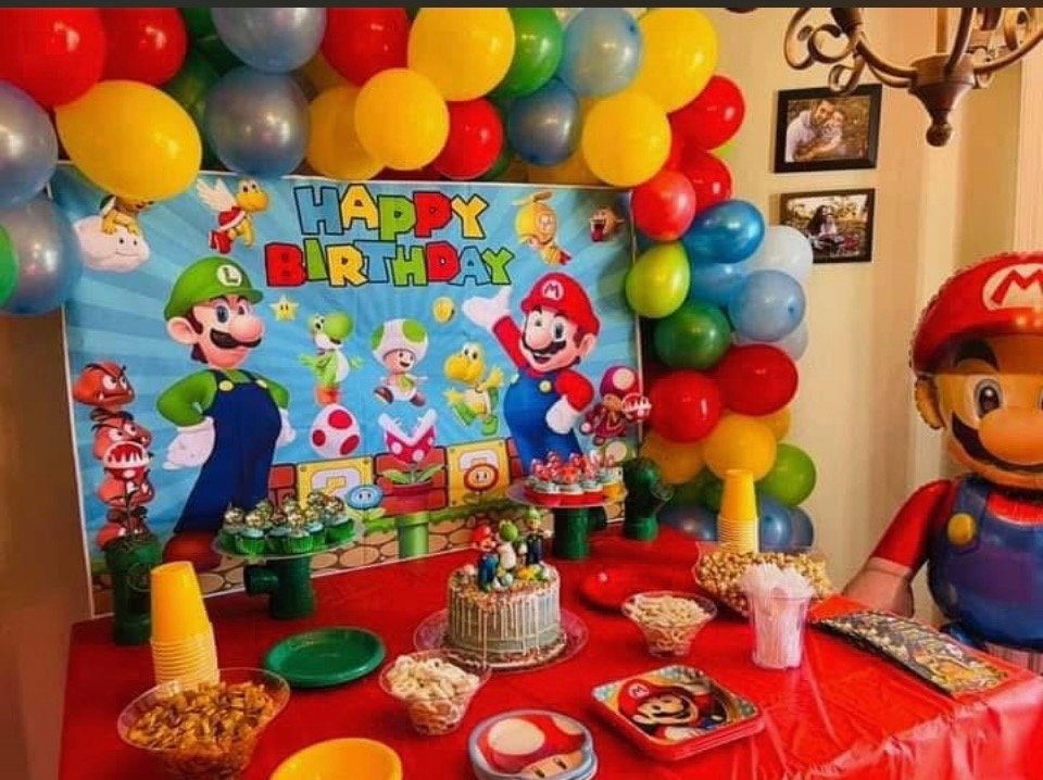 Closeup of a fun happy birthday sign featuring Mario Brothers with balloons and a cake